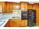 Kitchen with gas cooktop and lots of beautiful wood cabinets at 222 Weldon Cir, Mount Holly, NC 28120