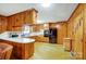 Eat-in kitchen with wood paneling, abundant cabinetry, modern black refrigerator and durable flooring at 222 Weldon Cir, Mount Holly, NC 28120