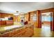 Spacious living room with wood paneling, a brick fireplace, and built-in shelving at 222 Weldon Cir, Mount Holly, NC 28120
