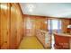 Bright living room featuring wood paneling and unique brick accents near the front door at 222 Weldon Cir, Mount Holly, NC 28120