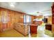 Cozy living area with classic wood paneling and convenient kitchen access at 222 Weldon Cir, Mount Holly, NC 28120