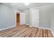 Bright bedroom with wood floors, white trim, and doors leading to the closet and hallway at 240 N Lackey St, Statesville, NC 28677