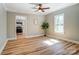 Inviting dining room featuring hardwood floors, neutral decor, a ceiling fan, and access to the kitchen, ideal for gatherings at 240 N Lackey St, Statesville, NC 28677