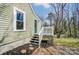 Side view of home features green siding, white trim, and a small back deck at 240 N Lackey St, Statesville, NC 28677