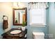Charming bathroom featuring a granite countertop vanity and a window with natural light at 2622 Rolling Ridge Dr, Hickory, NC 28602