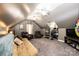 Spacious bonus room with a slanted ceiling, ceiling fans, neutral carpet, and entertainment area at 2622 Rolling Ridge Dr, Hickory, NC 28602