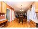 Open concept dining area flowing into the living room, hardwood floors, and modern light fixture at 2622 Rolling Ridge Dr, Hickory, NC 28602