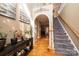 Bright foyer features an arched doorway, wooden floors, and staircase with a wooden railing at 2622 Rolling Ridge Dr, Hickory, NC 28602