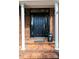 Classic black front door, brick facade, and white column accents enhance curb appeal at 2622 Rolling Ridge Dr, Hickory, NC 28602