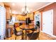 Open-concept kitchen features wood cabinets, black appliances, and an eat-in dining table at 2622 Rolling Ridge Dr, Hickory, NC 28602