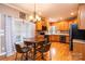 Eat-in kitchen with natural wood cabinetry, stainless steel appliances, and modern light fixture at 2622 Rolling Ridge Dr, Hickory, NC 28602