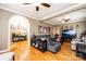 Open-concept living room featuring hardwood floors, fireplace, and gray sectional sofa at 2622 Rolling Ridge Dr, Hickory, NC 28602