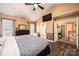 Bright main bedroom with wood floor, television, and doorway to ensuite bathroom at 2622 Rolling Ridge Dr, Hickory, NC 28602