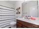 Bathroom boasts a modern vanity, framed mirror, and stylish shower with a striped curtain at 3046 Denali Way, Rock Hill, SC 29732