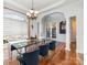 Elegant dining room boasts hardwood floors, detailed trim, modern chandelier, and french doors with natural light at 3046 Denali Way, Rock Hill, SC 29732