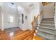 Bright and airy foyer featuring hardwood floors, stairs with carpet runner, and a front door with glass inserts at 3046 Denali Way, Rock Hill, SC 29732