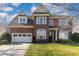 Charming brick two-story home featuring a well-manicured lawn and an attached two-car garage at 3046 Denali Way, Rock Hill, SC 29732