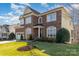 Beautiful brick and siding home featuring a well-manicured lawn, landscaping, and an attached two-car garage at 3046 Denali Way, Rock Hill, SC 29732