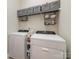 This laundry room is equipped with modern appliances, storage shelves and gray organizing cubes at 3046 Denali Way, Rock Hill, SC 29732