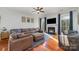 Cozy living room featuring hardwood floors, modern furnishings, fireplace, and large windows with natural light at 3046 Denali Way, Rock Hill, SC 29732