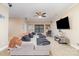 Spacious living room with neutral colors, plush sectional, ceiling fan, and entertainment center at 3046 Denali Way, Rock Hill, SC 29732