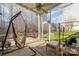 Cozy screened porch featuring a hanging hammock chair and comfortable seating area with natural lighting at 3046 Denali Way, Rock Hill, SC 29732