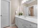 A well-lit bathroom with a single sink vanity, a large mirror, and a separate toilet room at 308 Covington Xing, Weddington, NC 28104