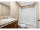 Bathroom with a cultured marble sink, white tub with shower, laminate floor, and a toilet at 3365 34Th Avenue Ne Ct, Hickory, NC 28601