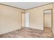 A bright bedroom with vinyl floors and light-colored walls leads to a closet and hallway at 3365 34Th Avenue Ne Ct, Hickory, NC 28601
