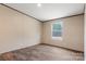 Bedroom with a window, vinyl floors, baseboard outlets, and light-colored walls with brown trim at 3365 34Th Avenue Ne Ct, Hickory, NC 28601