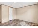 A simple bedroom with neutral walls, laminate floors, and a white door in the background at 3365 34Th Avenue Ne Ct, Hickory, NC 28601