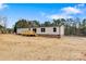 An exterior view of a beautiful home with a wooden porch against a blue sky backdrop at 3365 34Th Avenue Ne Ct, Hickory, NC 28601