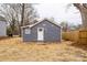 Exterior of backyard shed with vinyl siding, window, white door, and simple landscaping at 343 Bell St, Mooresville, NC 28115