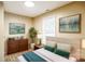 Cozy bedroom with light beige walls, hardwood floors, soft bedding and tasteful decorations at 343 Bell St, Mooresville, NC 28115