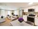 Open-concept living space featuring new stainless steel appliances and neutral-toned furniture at 343 Bell St, Mooresville, NC 28115