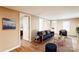 Comfortable living room with a blue sofa set, wood flooring, and an open doorway to the bedroom at 343 Bell St, Mooresville, NC 28115