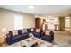 Inviting living room featuring a blue sectional sofa, stainless steel appliances, and an open floorplan at 343 Bell St, Mooresville, NC 28115