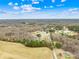 An aerial view shows trees and open land with residential homes with a beautiful blue sky at 348 Fleetwood Rd, York, SC 29745