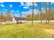 Spacious backyard featuring a wooden deck, partial fence, and mature trees at 348 Fleetwood Rd, York, SC 29745