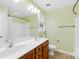 Bathroom with double sinks, wood cabinets and tub with shower at 348 Fleetwood Rd, York, SC 29745