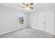 Well-lit bedroom featuring neutral carpet, walls, fan, and a large window at 348 Fleetwood Rd, York, SC 29745