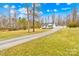 Charming single-story home featuring a well-manicured lawn and spacious driveway, surrounded by mature trees at 348 Fleetwood Rd, York, SC 29745