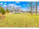 Charming single-story home featuring a well-manicured lawn and spacious driveway, surrounded by mature trees at 348 Fleetwood Rd, York, SC 29745