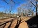 Overgrown backyard featuring shed and bare trees, showing property line at 4073 Lee Cline Rd, Conover, NC 28613
