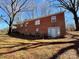Straight on exterior of brick home featuring a flat yard space, bare trees and multiple windows at 4073 Lee Cline Rd, Conover, NC 28613