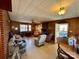 Cozy living room features a brick fireplace, wood paneling, and natural light at 4073 Lee Cline Rd, Conover, NC 28613