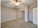Bedroom with a ceiling fan, neutral walls, carpeted floors, and mirrored closet doors at 4080 Elks Park Rd, Rock Hill, SC 29732