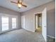 Bedroom with a ceiling fan, neutral walls, carpeted floors, and access to outdoor patio at 4080 Elks Park Rd, Rock Hill, SC 29732