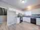 Bright kitchen with wood flooring, white cabinets, and black appliances at 4080 Elks Park Rd, Rock Hill, SC 29732