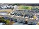 New construction aerial featuring a dense townhome community near a green athletic field and upscale apartments at 419 Burr St, Indian Trail, NC 28079